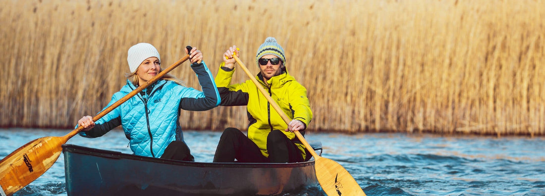 Man and woman paddling a canoe.