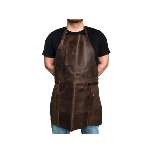 A front view of the Beavercraft Adjustable Brown Leather Work Apron on a model wearing a black shirt against a white background.