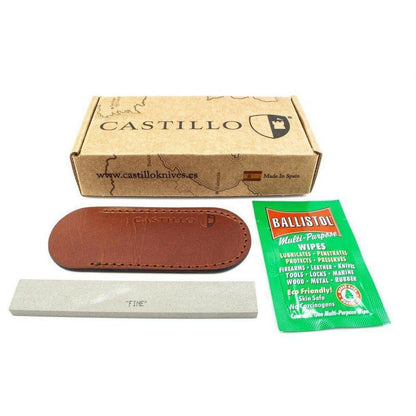 A box of Castillo knives with a brown leather sheath, a white sharpening stone, and Ballistol wipes on a white background.