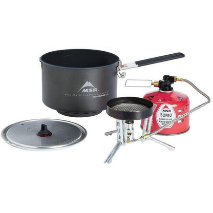 A top-down view of the MSR WindBurner Group Stove System with the charcoal pot, red gas canister, and silver lid visible against a white background.