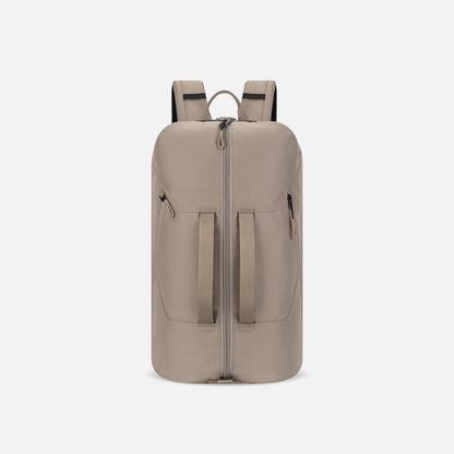 Front view of the Sherpani Juno | Travel Backpack in Dune Tan with a zippered top and two front pockets against a white background.