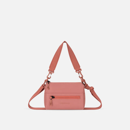 Front view of the Sherpani Skye Shoulder Bag in Desert Pink with a zippered pocket and adjustable strap against a white background.