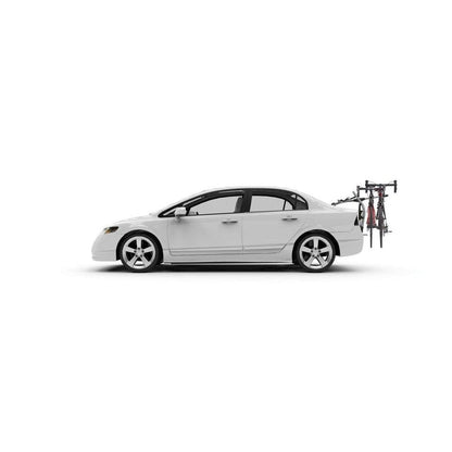 Side view of the Yakima HalfBack 3 car rack holding two bikes against a white background.